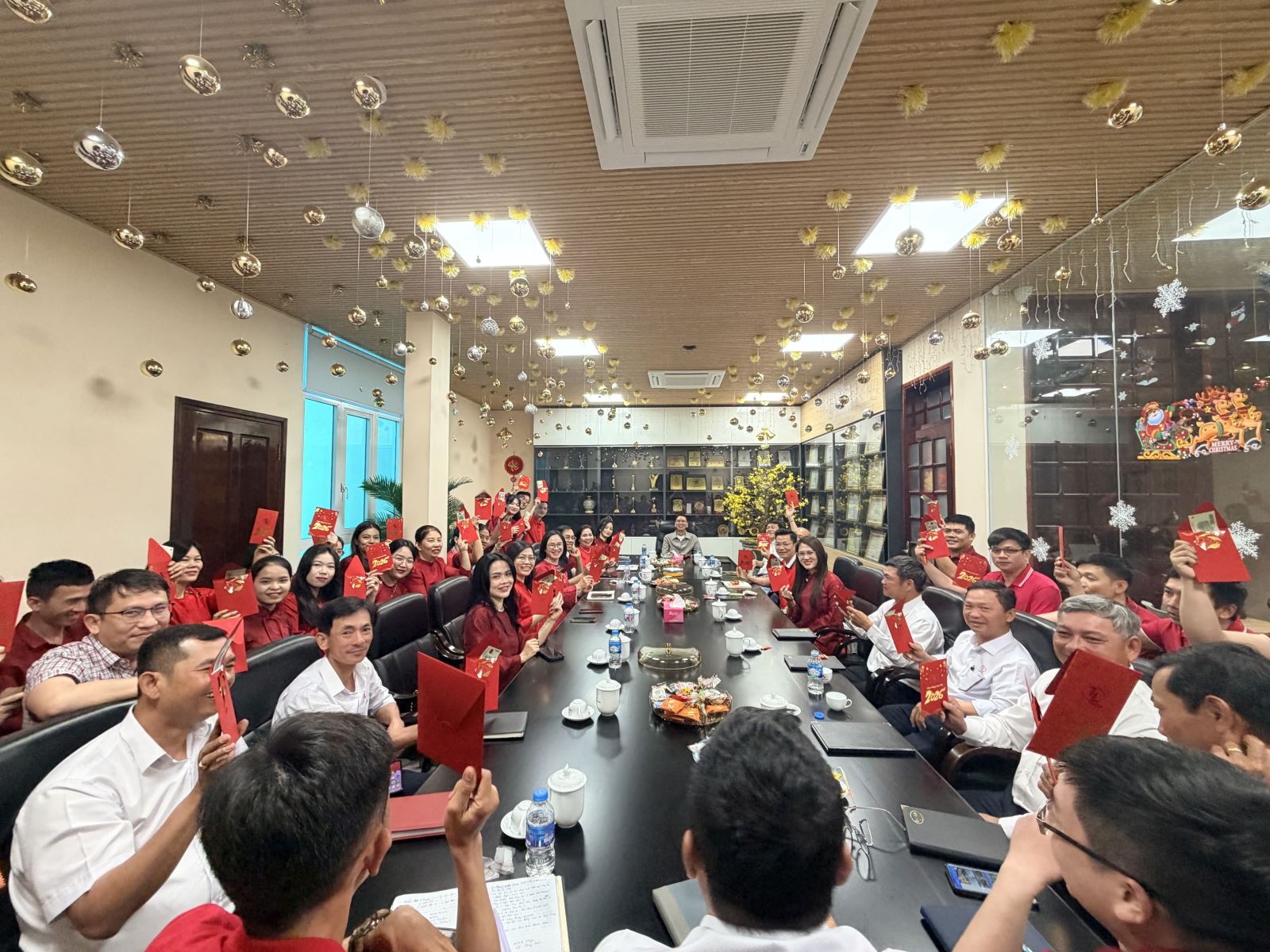 Handing out red envelopes to staff